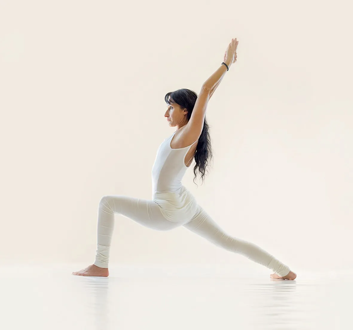 MRY Intro: a yogini in a lunge with arms raised