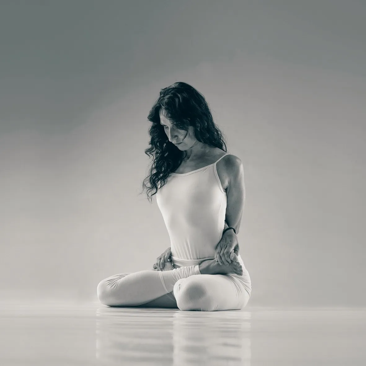 MRY Advanced II: a yogini sitting cross-legged